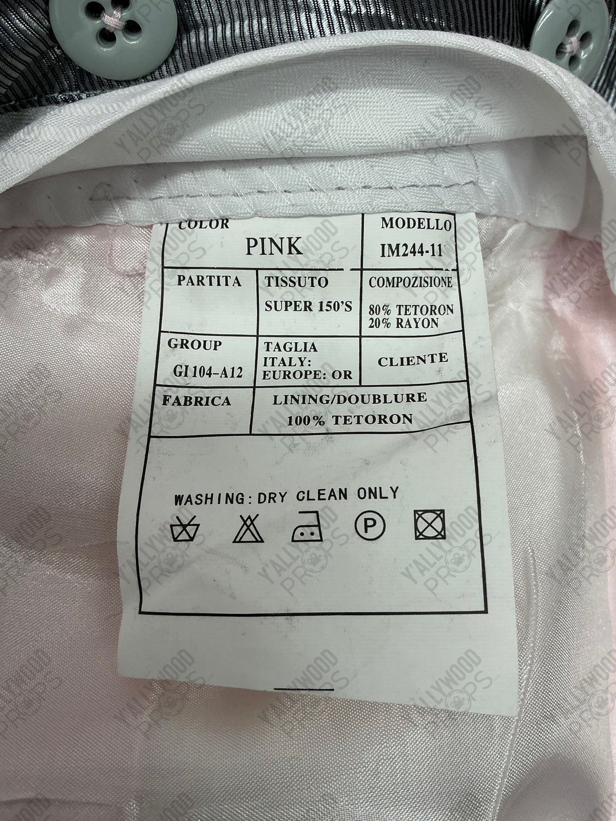 Care label for pink garment with tetoron and rayon blend fabric, showing dry clean only instructions and Italian manufacturer