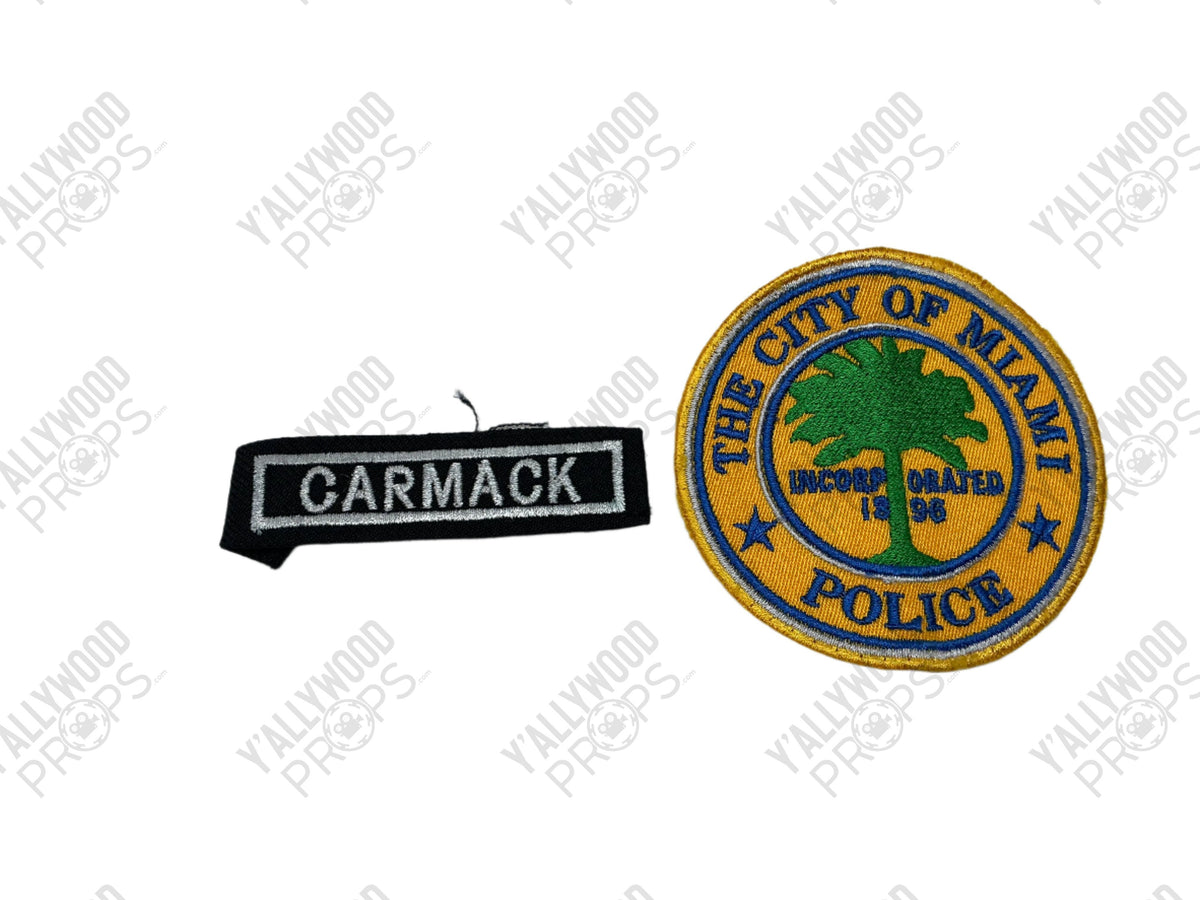 Two embroidered patches: black rectangular "Carmack" nameplate and circular blue and gold "City of Miami Police" badge with p