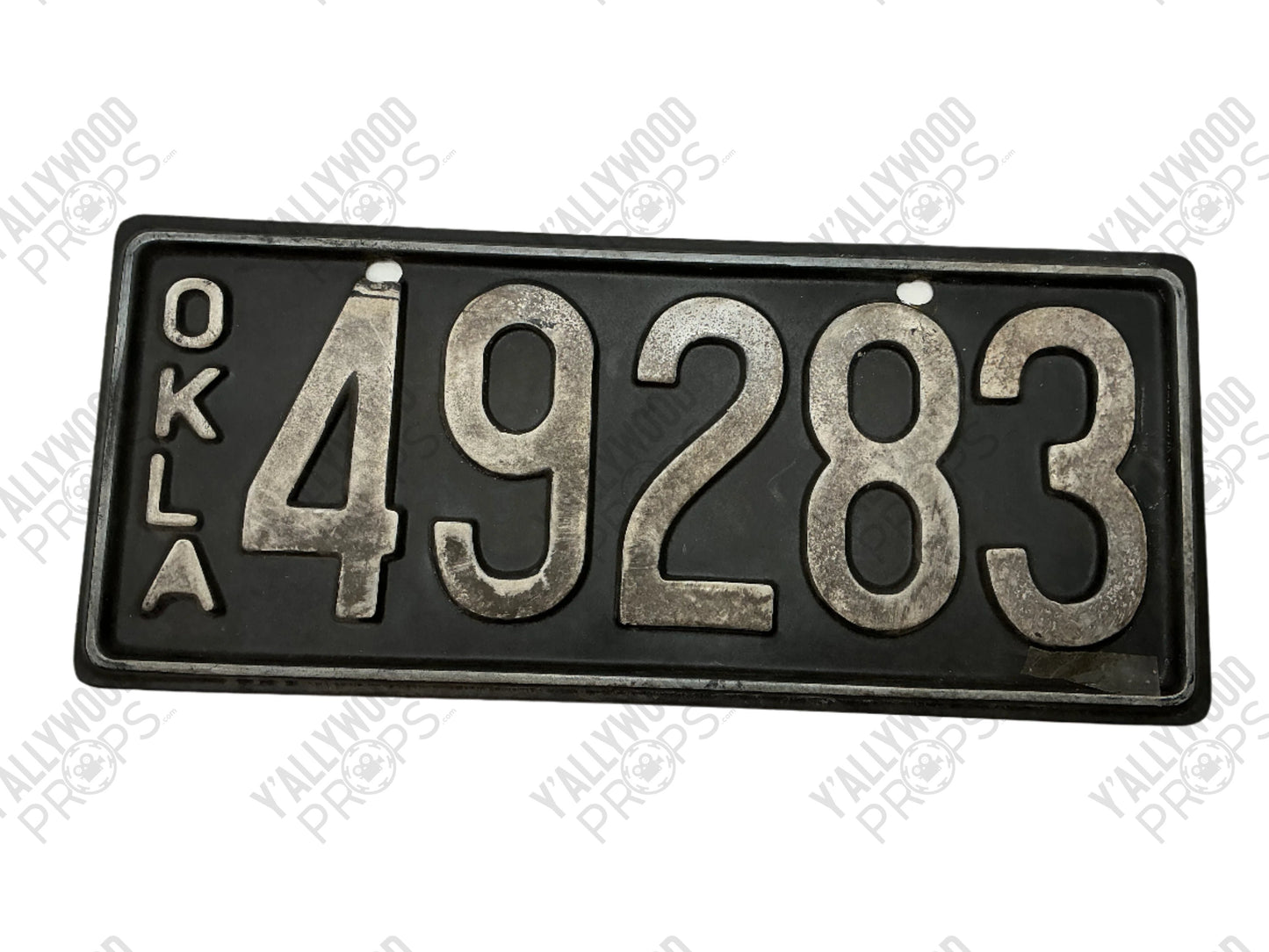 Black Oklahoma license plate reading "OKLA 49283" with distressed metal numbers and border.