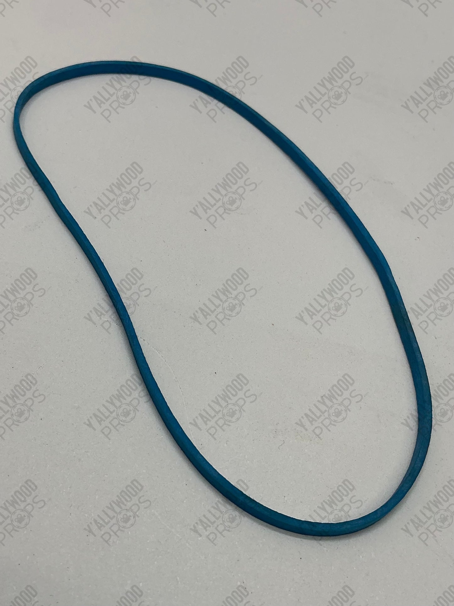 Teal-blue elastic band or rubber loop on white background.